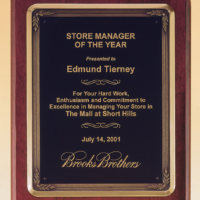 Main Image of Rosewood stained piano finish plaque with antique bronze plated metal frame casting.