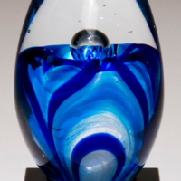 Main Image of Art glass egg with blue and white accents on black glass base